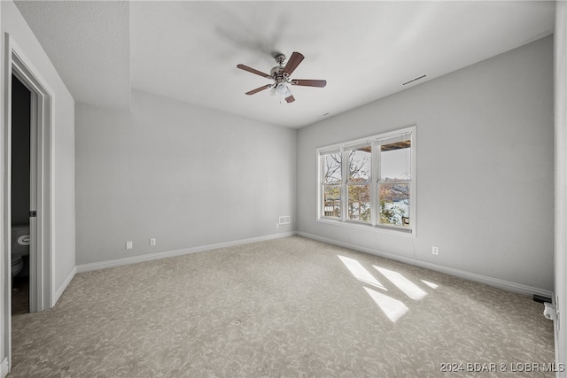 empty room with ceiling fan and carpet