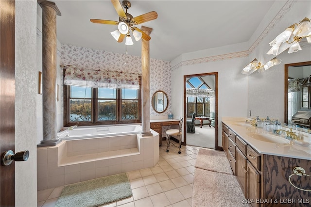 bathroom featuring tile patterned floors, tiled tub, ceiling fan, and vanity