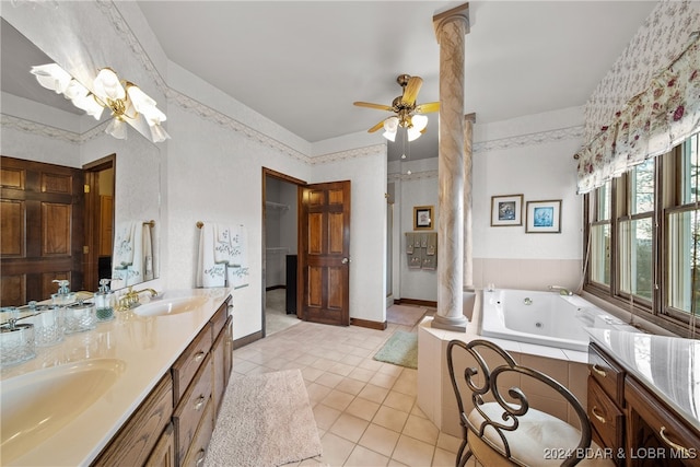 bathroom with vanity, tile patterned flooring, ceiling fan, ornate columns, and tiled tub