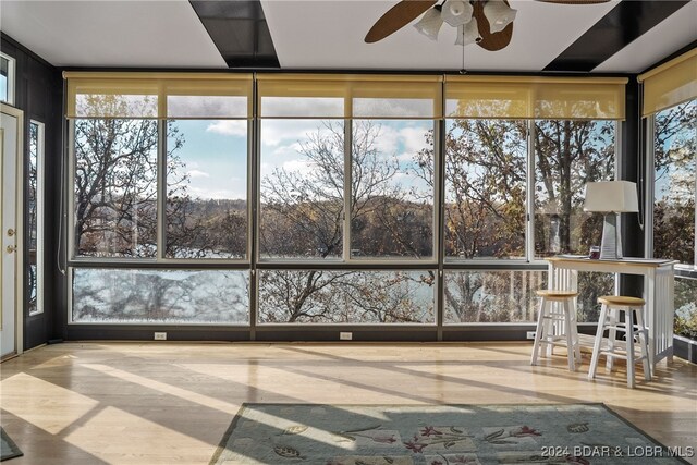 unfurnished sunroom featuring ceiling fan