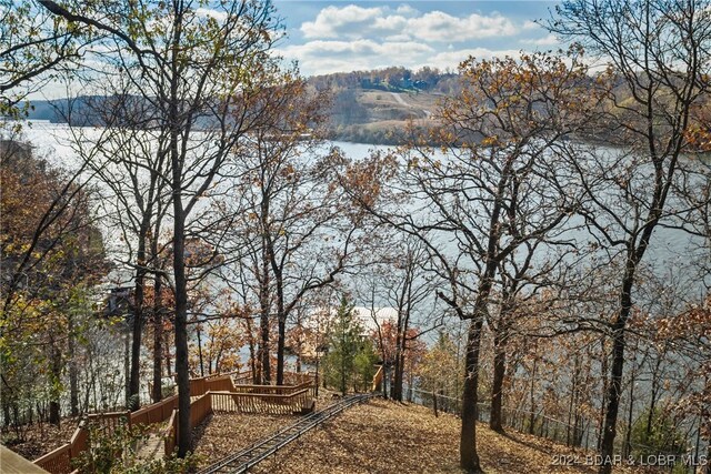 view of yard with a deck with water view