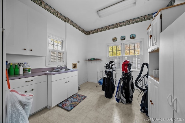 laundry area with hookup for a washing machine, sink, and cabinets