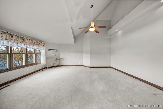 unfurnished room with carpet, ceiling fan, and high vaulted ceiling