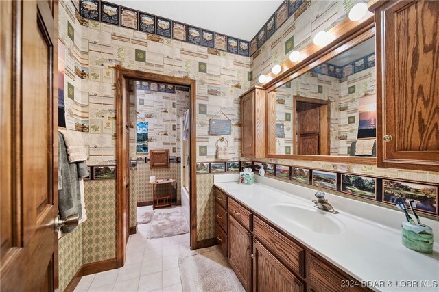 bathroom featuring tile patterned flooring, vanity, and tile walls