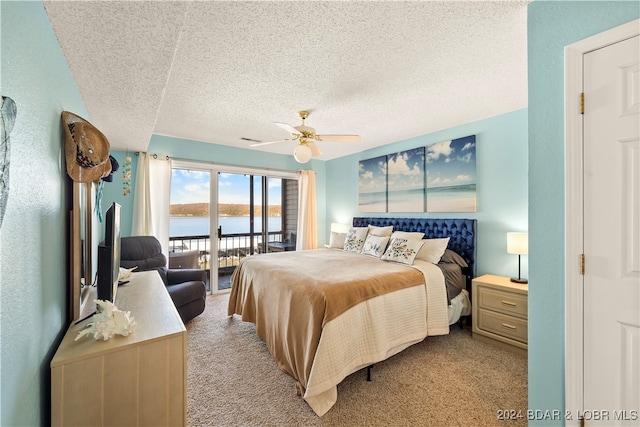 bedroom with ceiling fan, light colored carpet, a textured ceiling, and access to outside