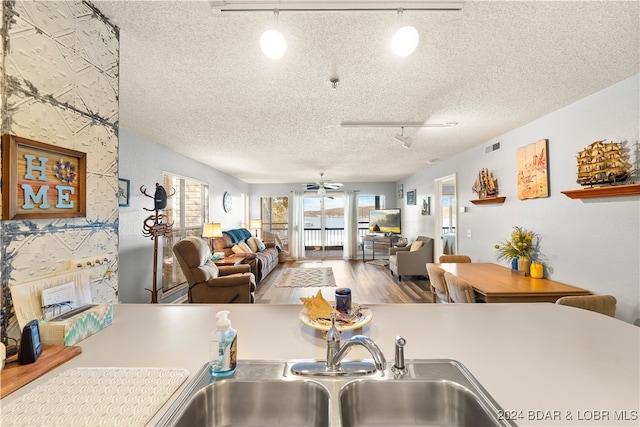 kitchen featuring ceiling fan, a textured ceiling, and track lighting