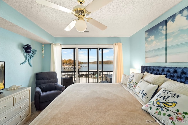 bedroom with carpet, a textured ceiling, access to outside, ceiling fan, and a water view