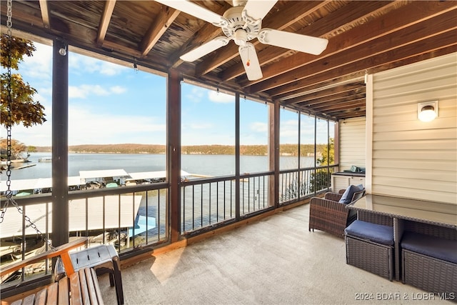 sunroom / solarium featuring ceiling fan, a water view, and plenty of natural light