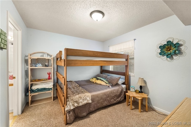 carpeted bedroom with a textured ceiling