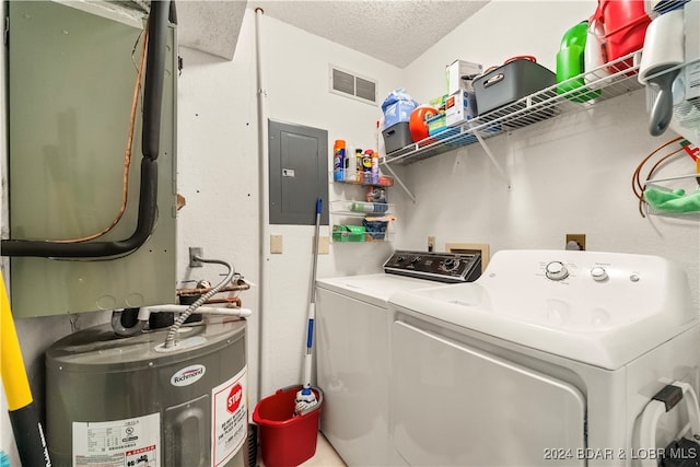 washroom featuring washer and dryer, a textured ceiling, electric panel, and water heater