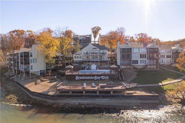 back of property featuring a water view