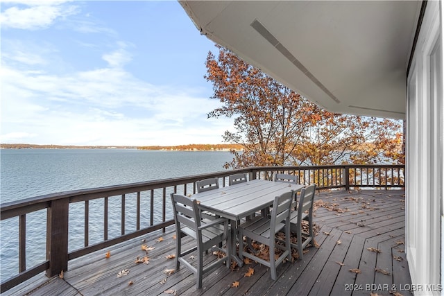 wooden terrace featuring a water view