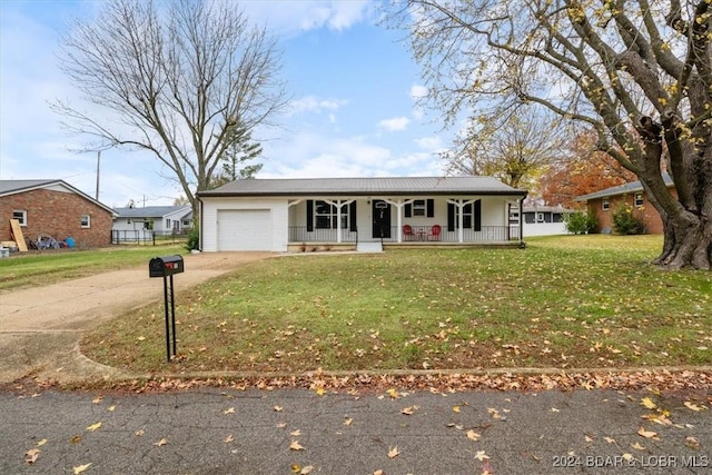 ranch-style home with a front yard, concrete driveway, covered porch, and an attached garage