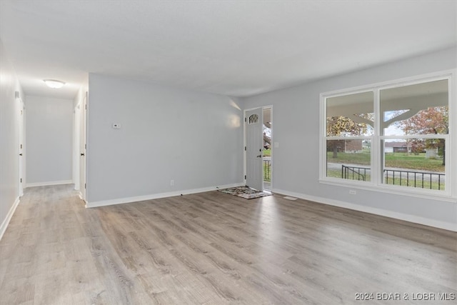 interior space with light wood-type flooring and baseboards