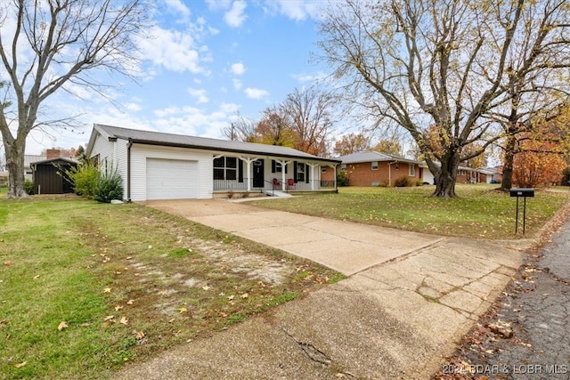 ranch-style house featuring a garage, driveway, covered porch, and a front yard