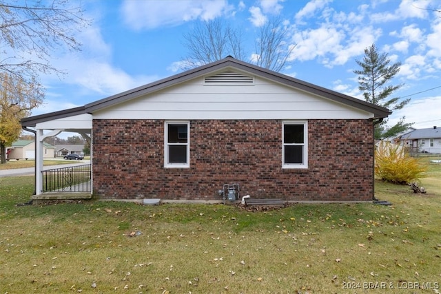 view of home's exterior with a yard and brick siding