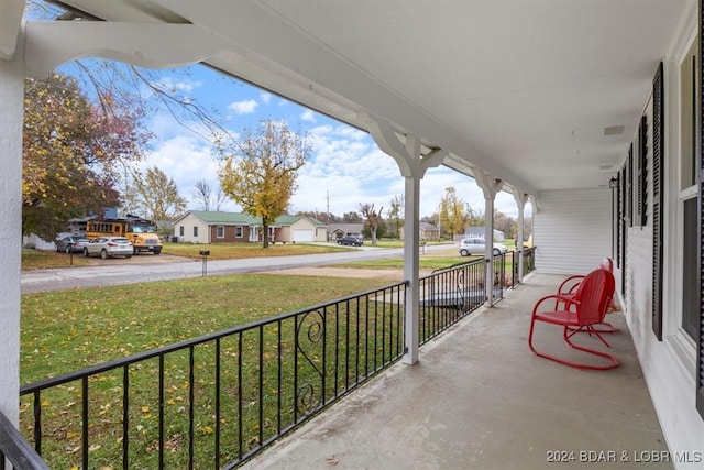 view of patio / terrace featuring covered porch and a residential view