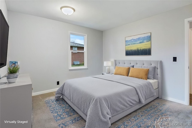 bedroom with carpet floors and baseboards