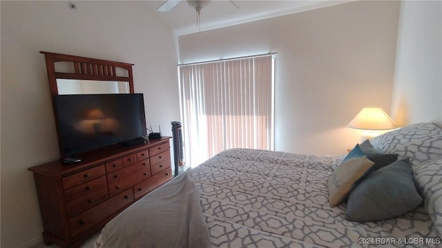 bedroom featuring ceiling fan and vaulted ceiling