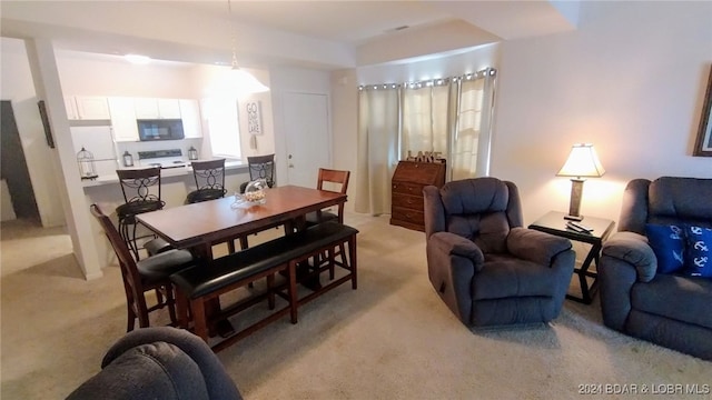 dining room with light colored carpet