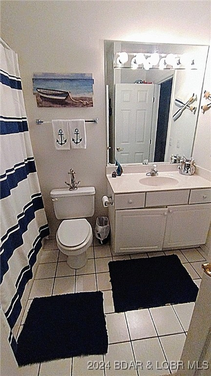 bathroom featuring tile patterned floors, vanity, and toilet