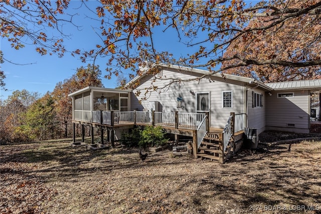 rear view of house with a deck and a sunroom