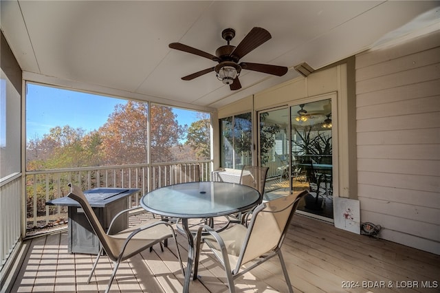 sunroom with ceiling fan and lofted ceiling