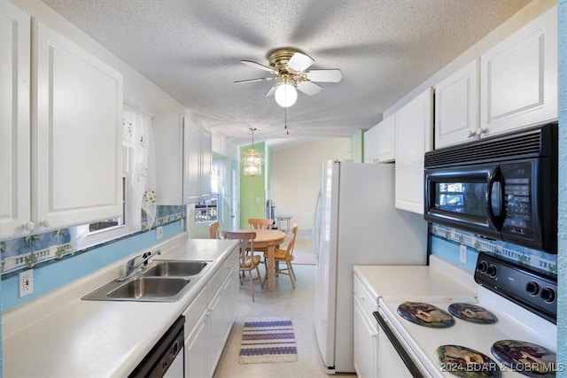 kitchen with white appliances, sink, hanging light fixtures, a textured ceiling, and white cabinetry