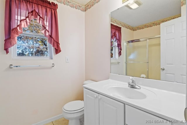 bathroom featuring tile patterned floors, vanity, toilet, and an enclosed shower