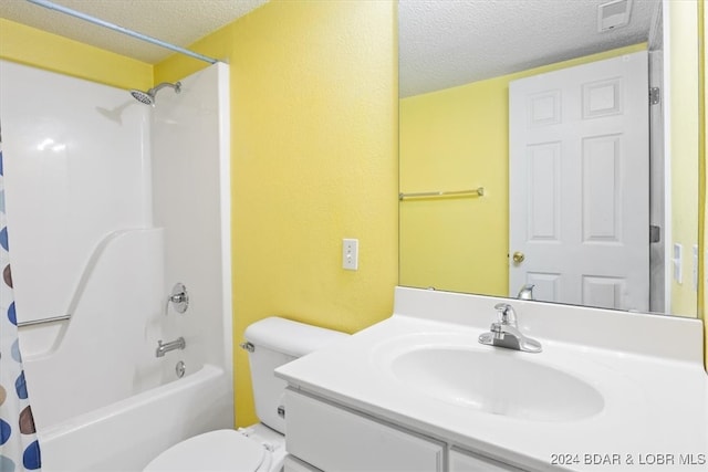 full bathroom with vanity, shower / bath combination with curtain, a textured ceiling, and toilet