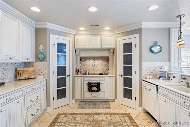 kitchen with white cabinetry, decorative light fixtures, decorative backsplash, light tile patterned floors, and ornamental molding