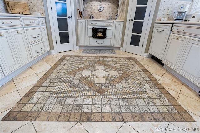 kitchen featuring white cabinetry and light tile patterned floors