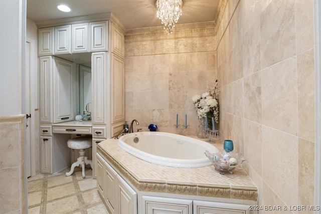 bathroom with a bathtub, tile walls, and an inviting chandelier