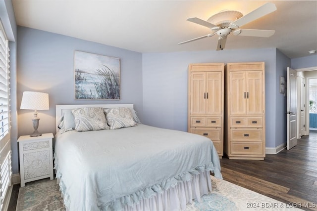 bedroom with multiple windows, dark hardwood / wood-style floors, and ceiling fan