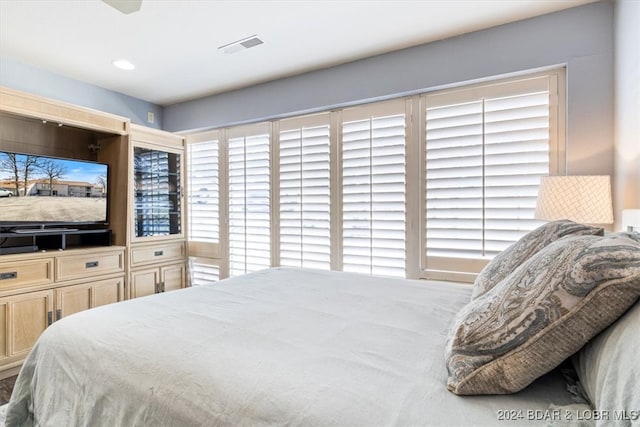 carpeted bedroom with multiple windows