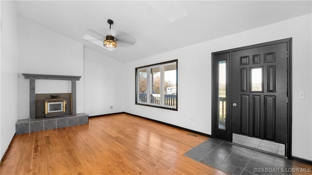 foyer with a skylight, hardwood / wood-style flooring, and ceiling fan