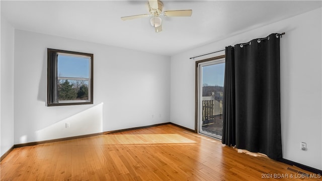 spare room with hardwood / wood-style flooring and ceiling fan