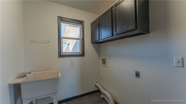 laundry room featuring electric dryer hookup, cabinets, sink, and hookup for a washing machine