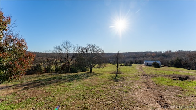 view of yard with a rural view