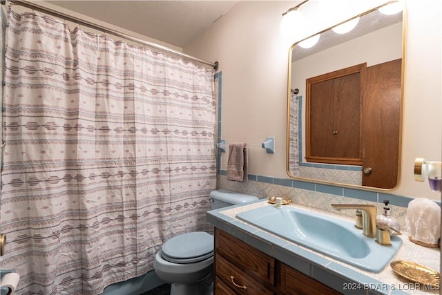 bathroom with vanity, toilet, and curtained shower