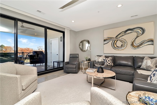 living room featuring light hardwood / wood-style floors and ceiling fan