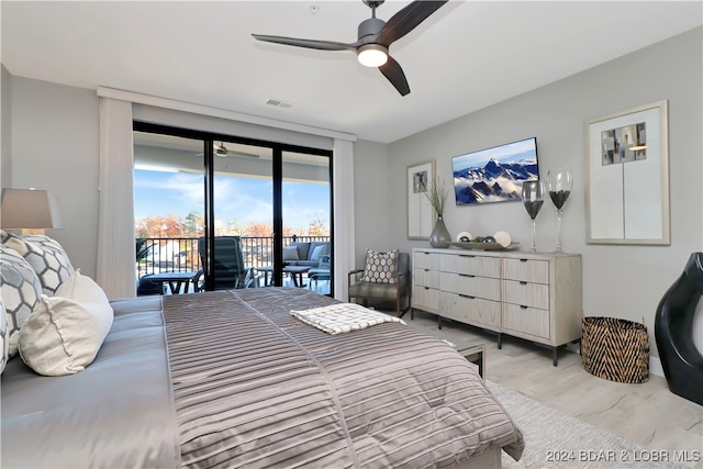 bedroom with access to exterior, ceiling fan, and expansive windows