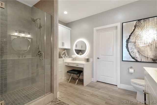 bathroom with vanity, hardwood / wood-style flooring, toilet, and walk in shower