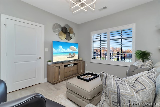 living room featuring light hardwood / wood-style floors and a chandelier