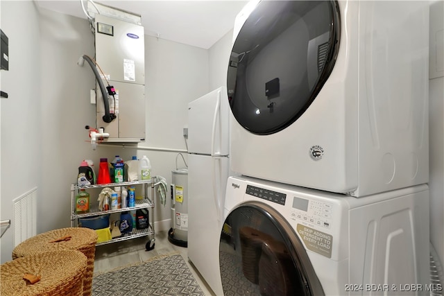 washroom with electric water heater, light hardwood / wood-style flooring, and stacked washer and clothes dryer