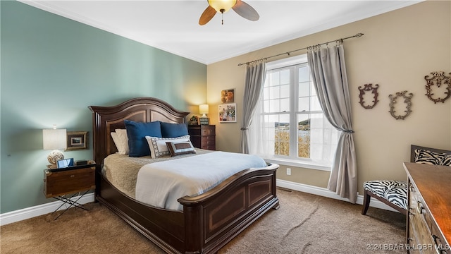 bedroom with ceiling fan, ornamental molding, and carpet floors