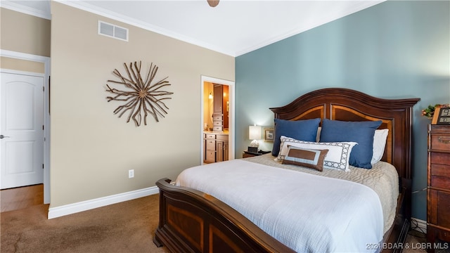 bedroom featuring ensuite bath, ornamental molding, and carpet floors