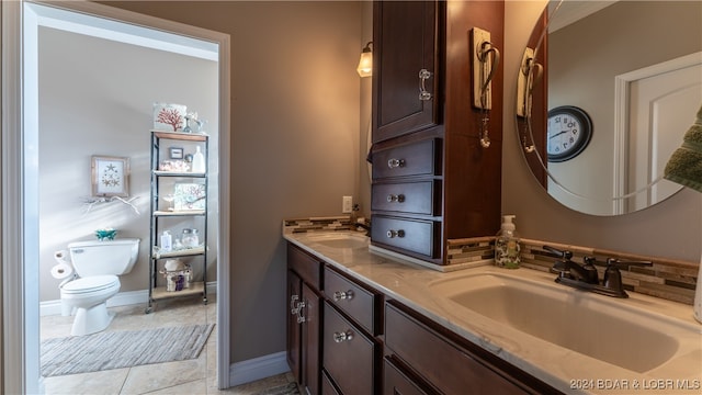 bathroom with vanity, tile patterned floors, and toilet