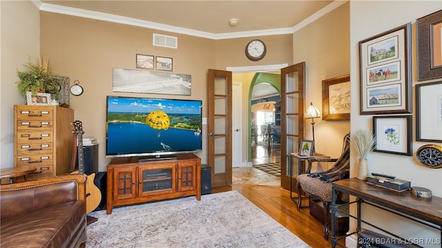 sitting room featuring crown molding and light hardwood / wood-style floors