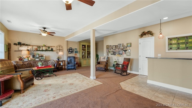 living room featuring light tile patterned floors and ceiling fan